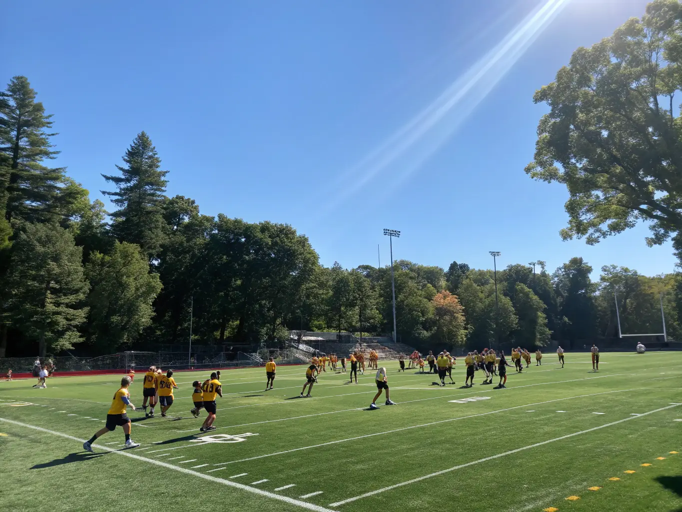 A vibrant image showing young football players participating in a training session, with coaches providing guidance and encouragement. The setting is a well-maintained football field with clear weather.